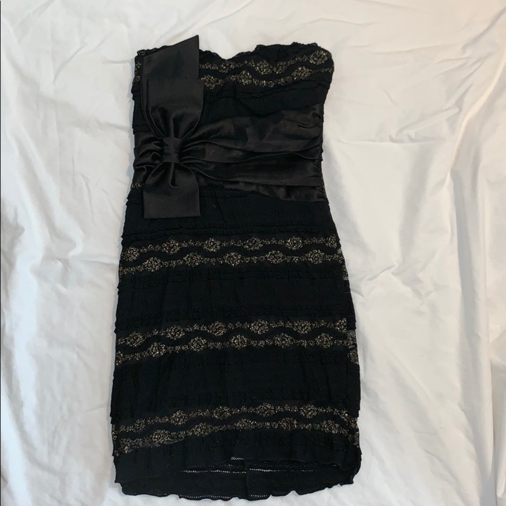 Little black dress with gold and a big bow